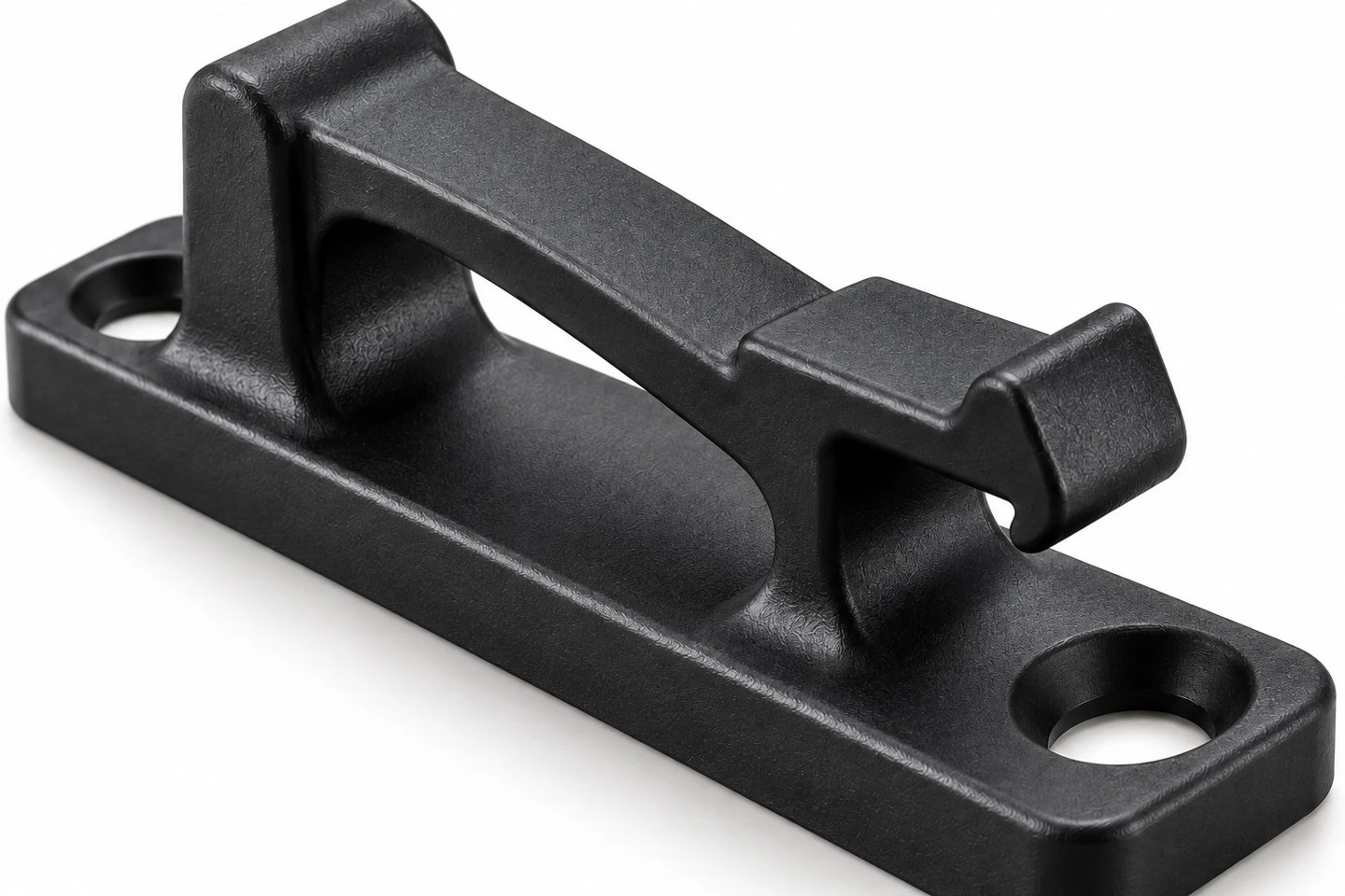 Close view of the spring bridge mounting holes and retention lip of a custom molded panel clip