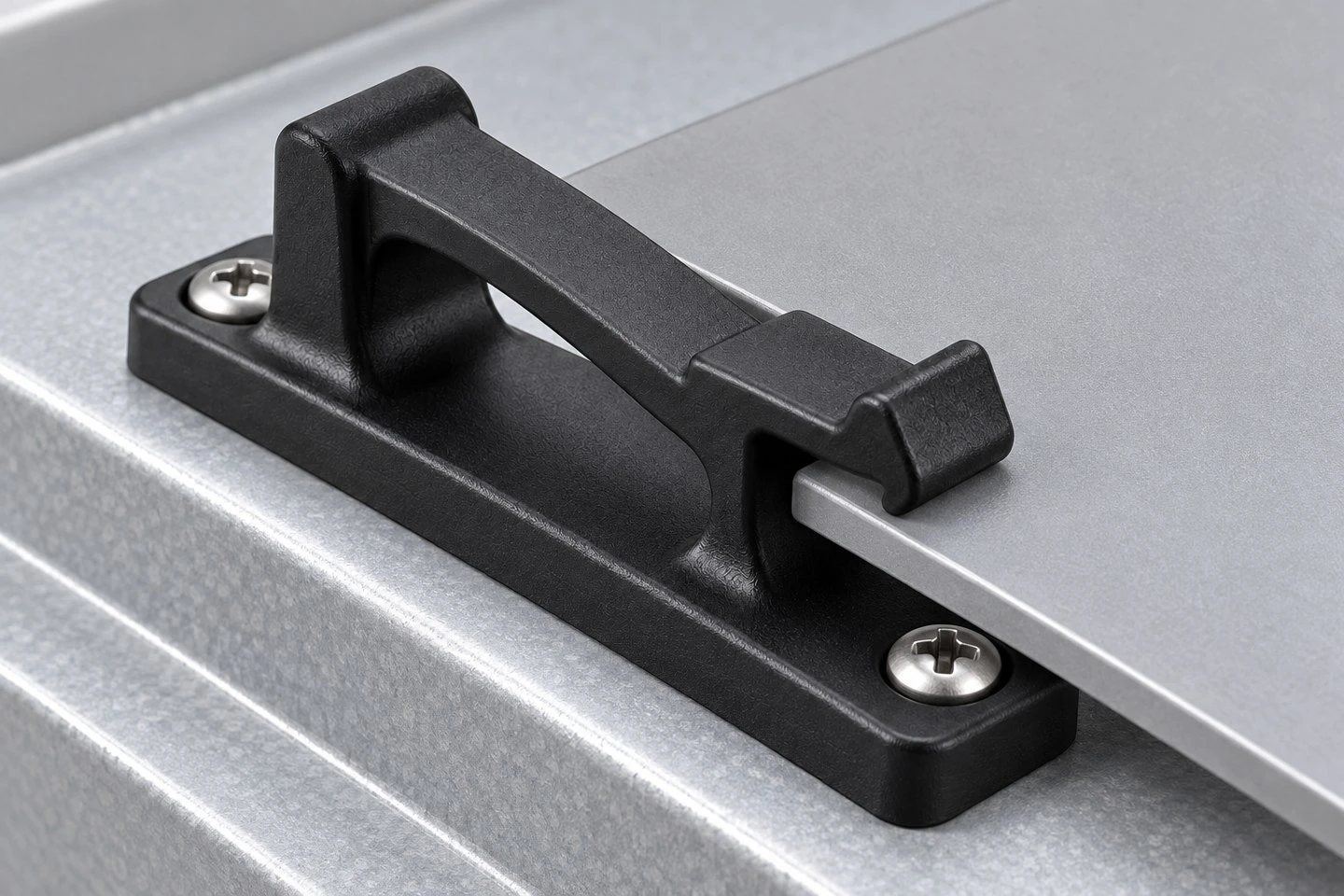 Illustrative custom plastic panel clip mounted on a sheet metal frame and engaging a removable panel edge