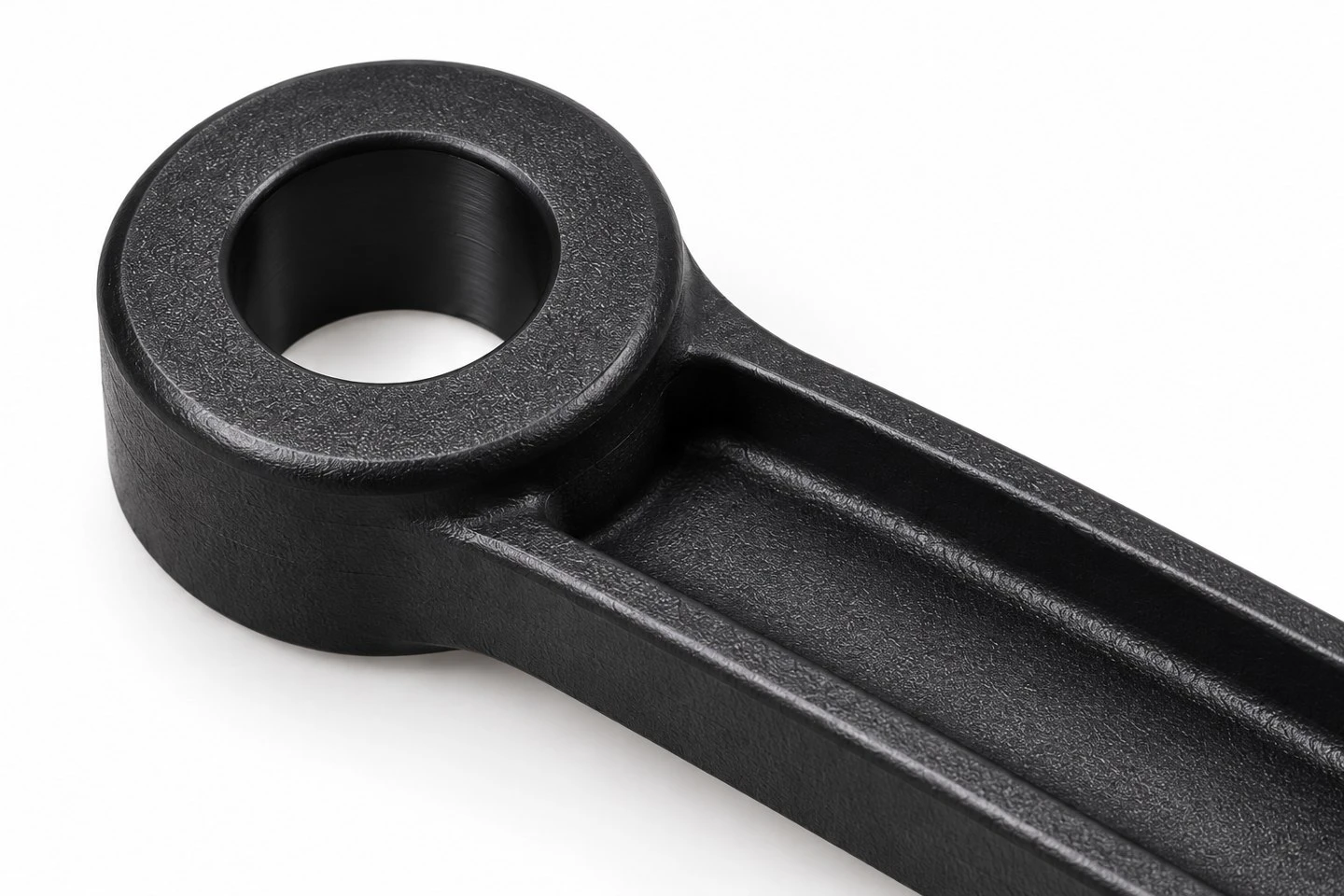 Close view of custom molded plastic linkage arm pivot boss bore and connecting ribs