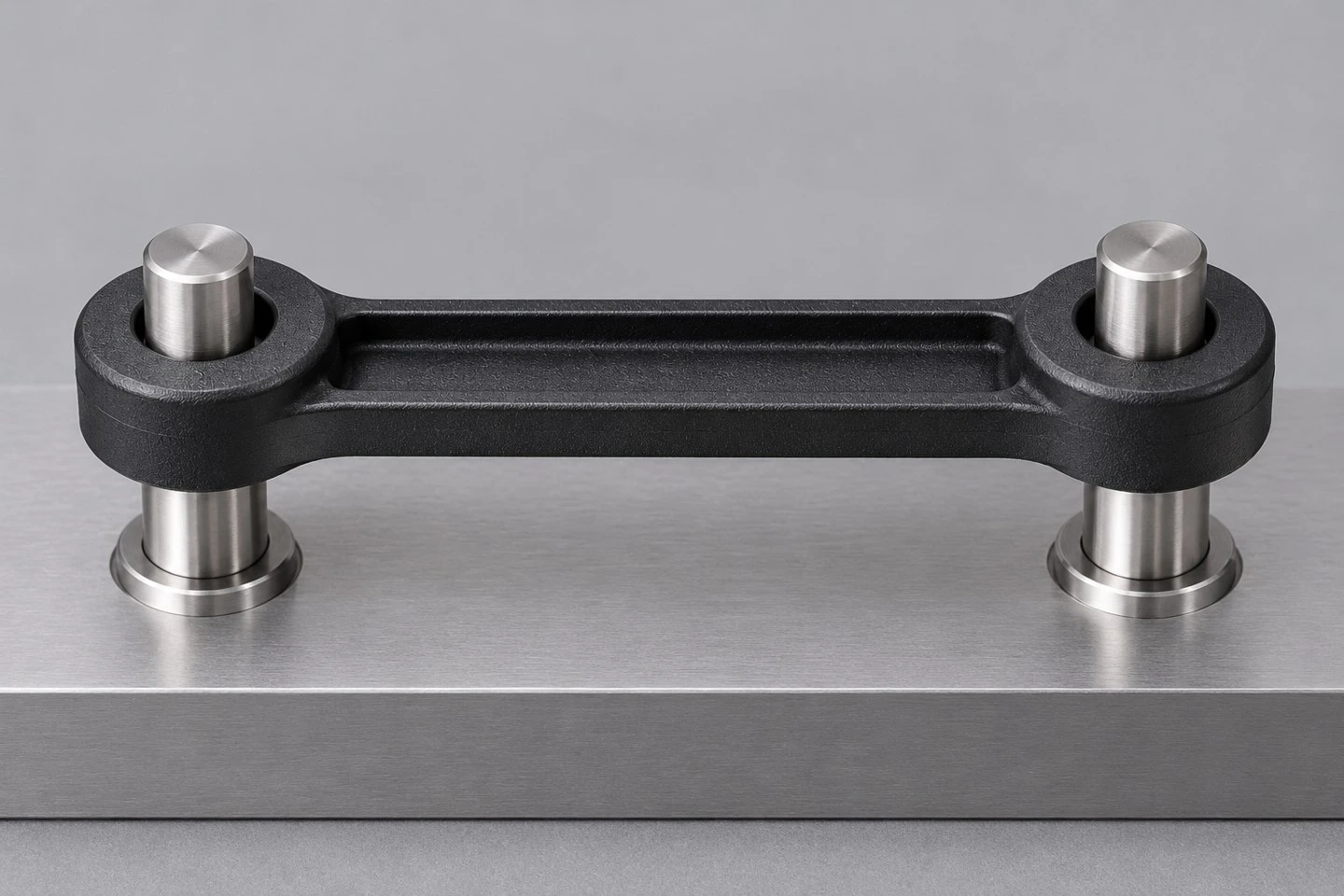 Illustrative custom plastic linkage arm positioned between two pivot pins in a compact mechanism