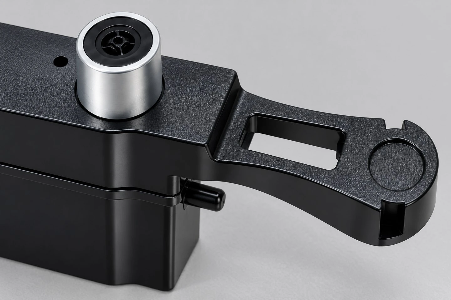 product-1-1 Detailed view of the slotted mounting arm and rounded locating feature on a custom injection molded housing